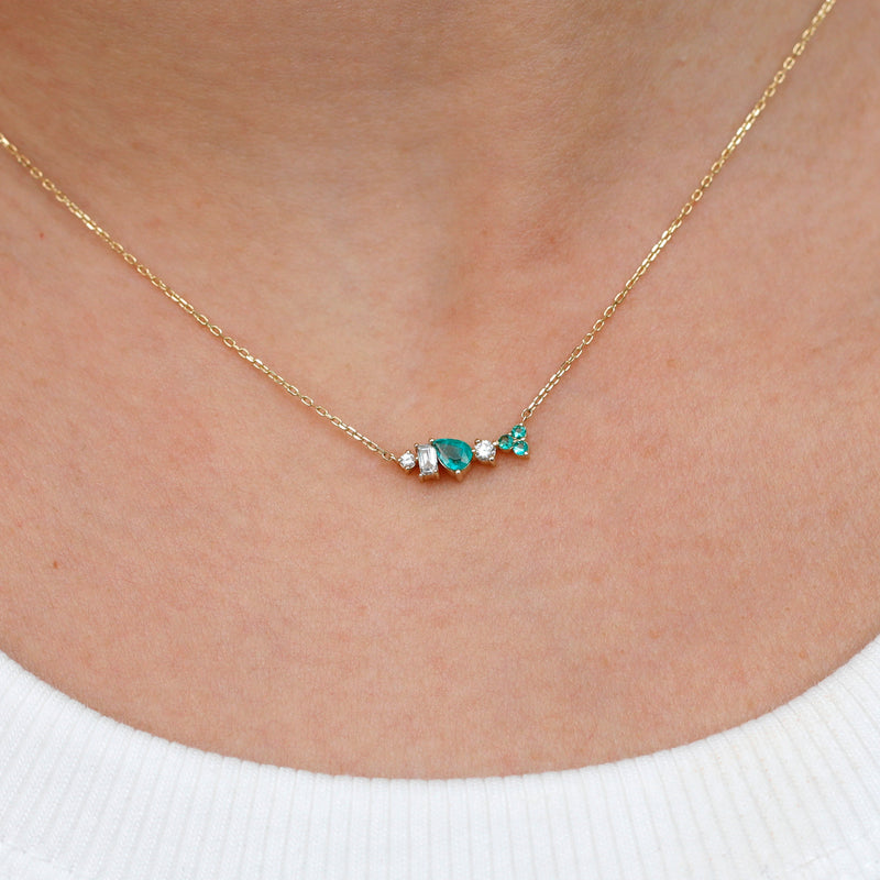 solid gold minimalist unique design necklace with natural diamonds and emeralds