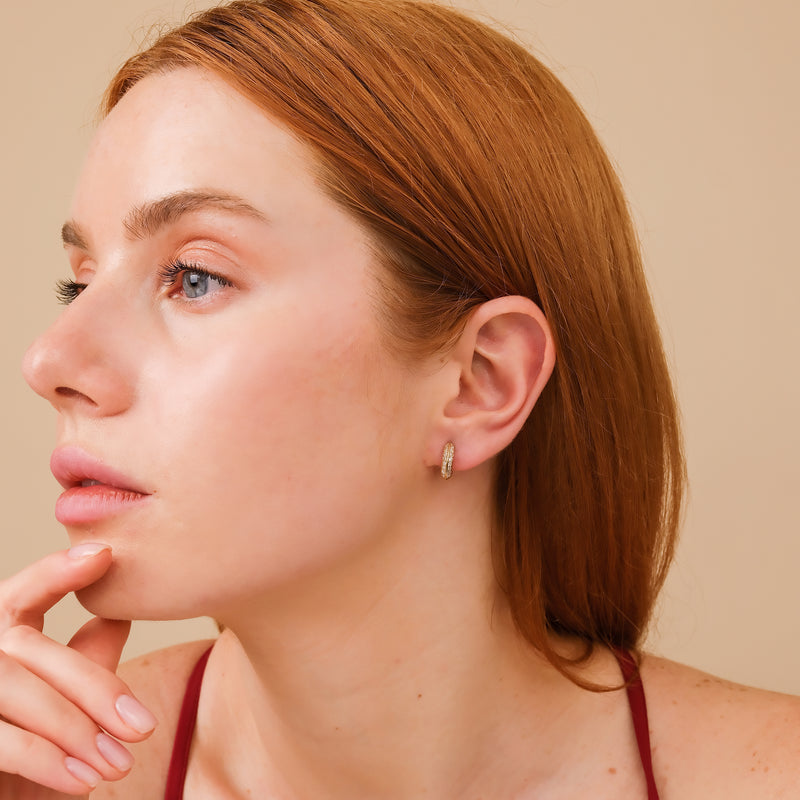 model wears dainty double edged hoop huggie lined in natural white diamonds april birthstone gift for her