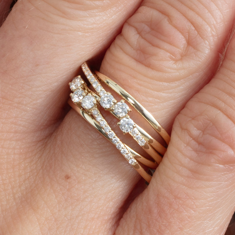 multiple stacked gold bands with diamond accents 