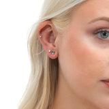 Model wears dainty ethically sourced baguette emerald diamond stud