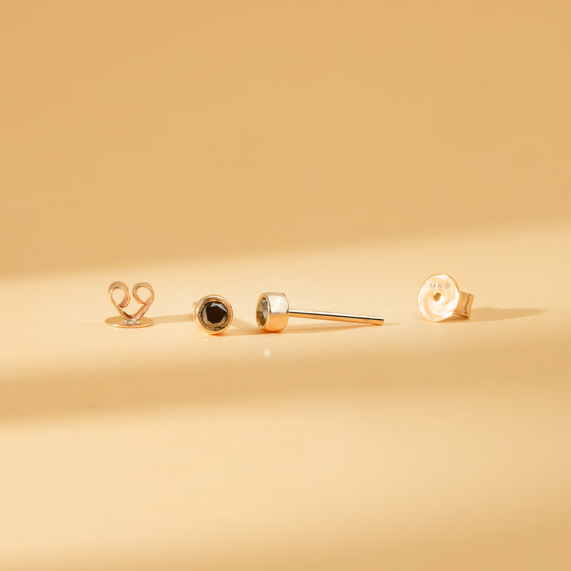 Pair of solid 14k gold black diamond bezel stud earrings