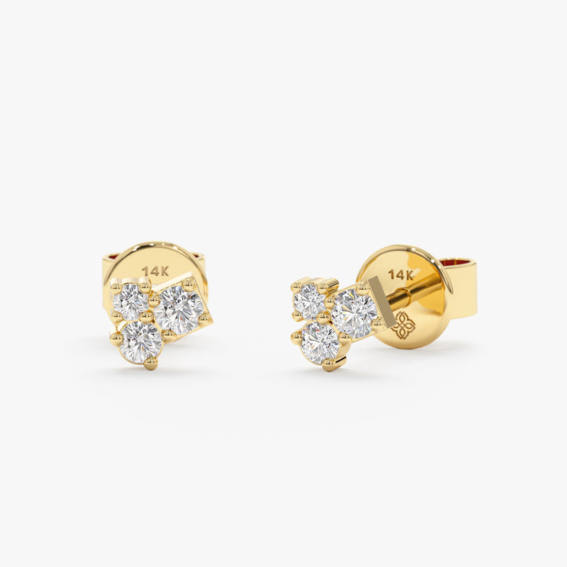 Handmade pair of solid 14k gold stud earrings with three diamonds