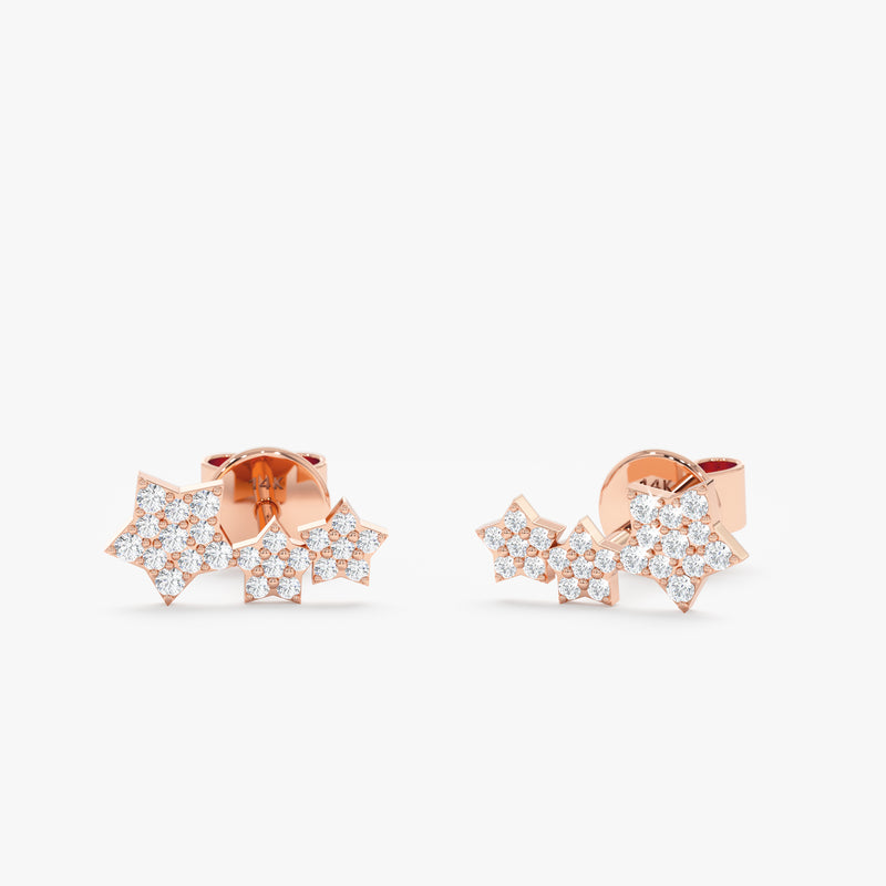 handmade pair of solid 14k rose gold triple star stud earrings with paved diamonds