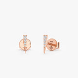 handmade pair of solid 14k rose gold stud earrings in spike shape with lined diamonds