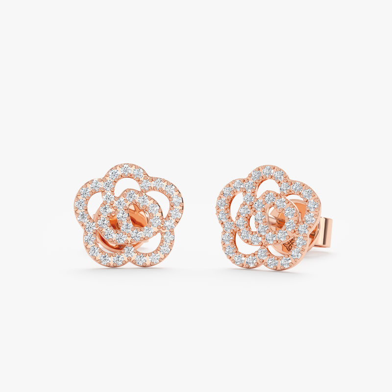 handmade pair of solid 14k rose gold rose shape stud earrings lined in diamonds 