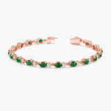 Luxurious 14k rose gold tennis bracelet with diamonds and emeralds