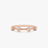 solid rose gold textured station ring with four white diamond bezels 