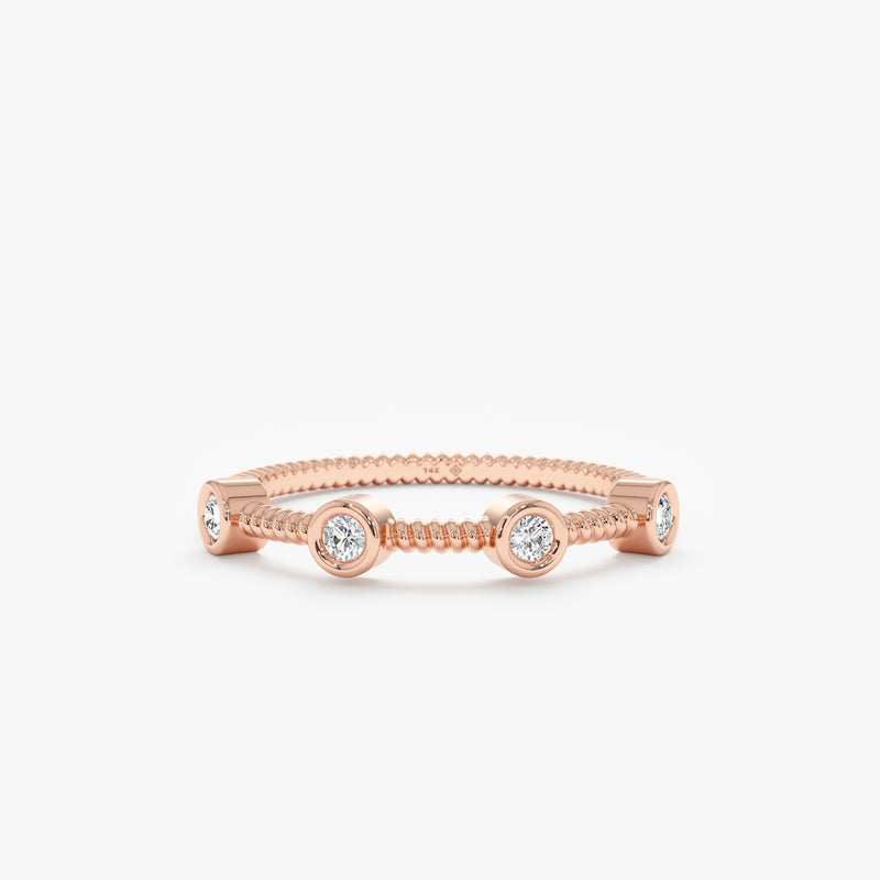 solid rose gold textured station ring with four white diamond bezels 