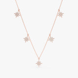 handcrafted solid 14k rose gold necklace with multiple hanging starburst charms with diamonds