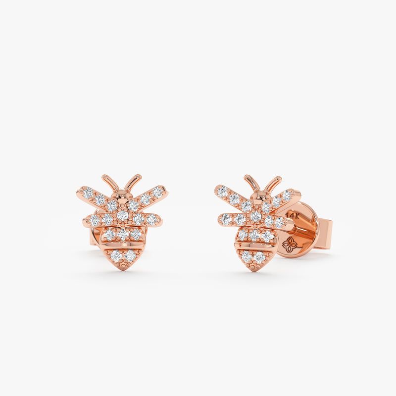 handmade pair of solid 14k rose gold stud earrings in bee shape with paved diamonds