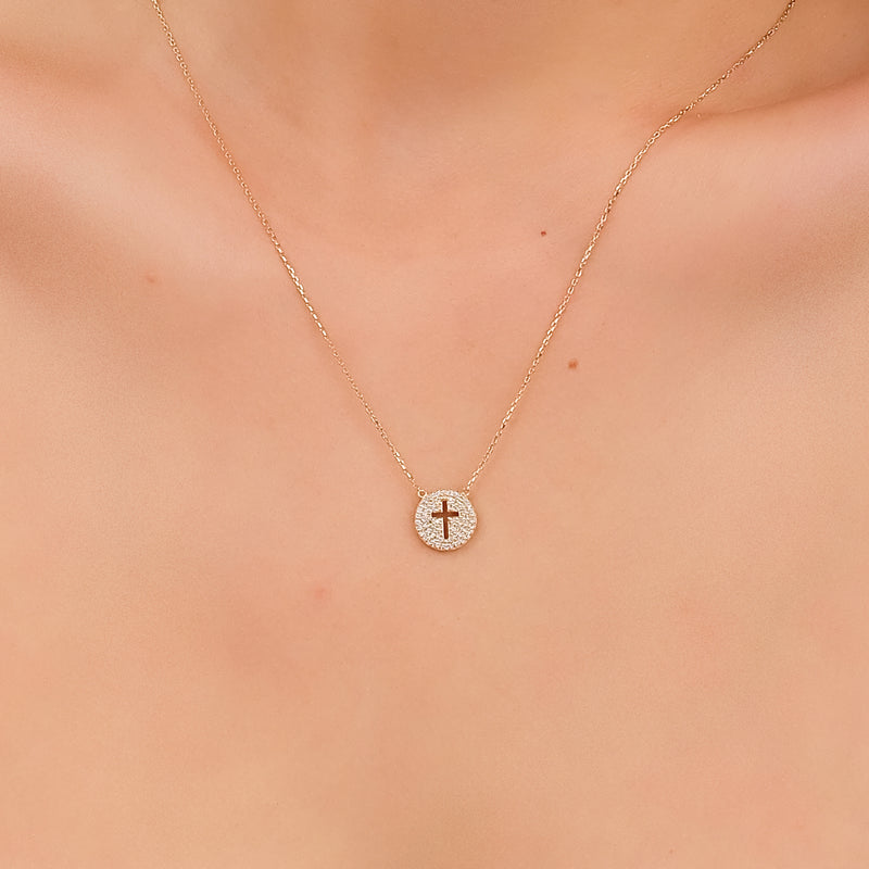 Unique cross pendant necklace with a cutout and sparkling diamonds in gold