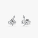 Handcrafted pair of oslid 14k white gold snake shape stud earrings with diamonds