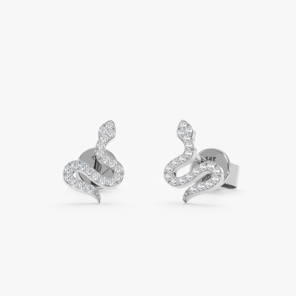 Handcrafted pair of oslid 14k white gold snake shape stud earrings with diamonds