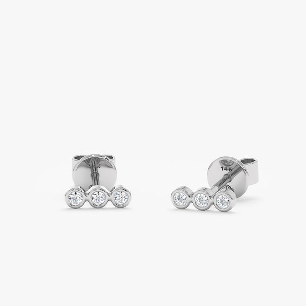 handcrafted pair of solid 14k white gold three bezel diamond stud earrings