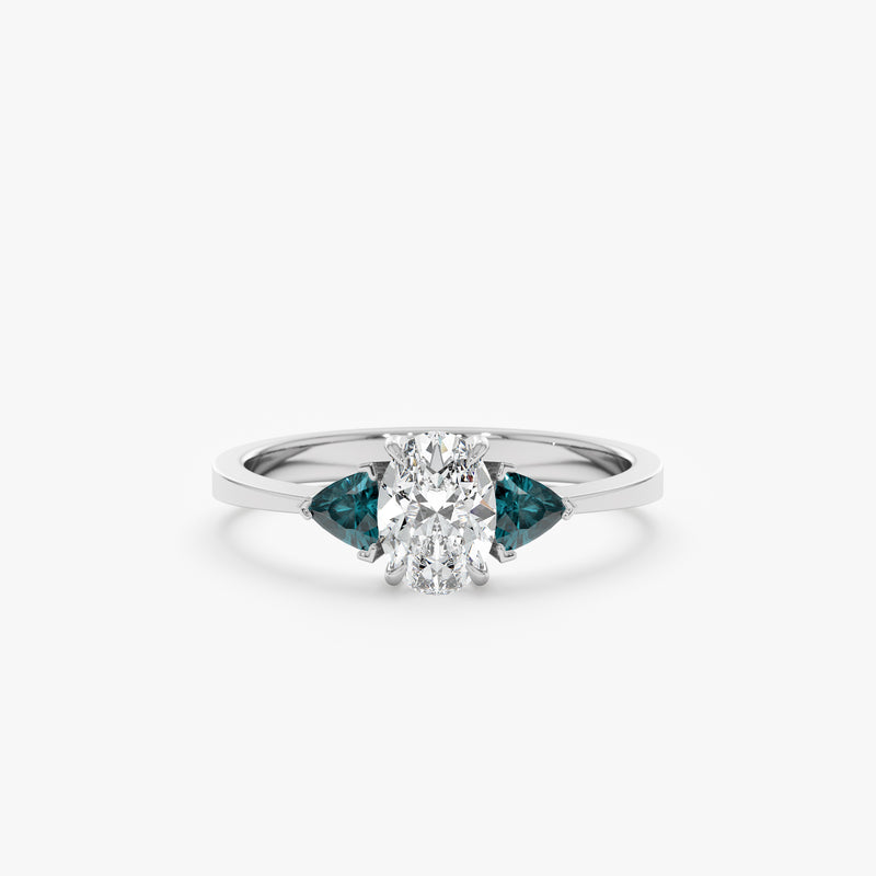 oval cut diamond ring flanked by two triangle cut teal sapphires in 14k white gold