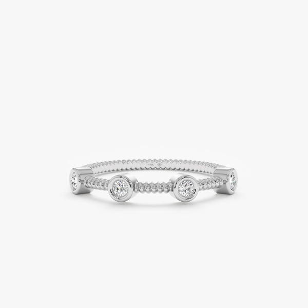 solid white gold station ring with ribbed texture and white diamonds 