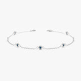 solid white gold blue topaz station bracelet 