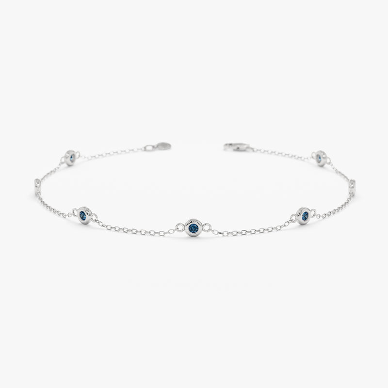 solid white gold blue topaz station bracelet 