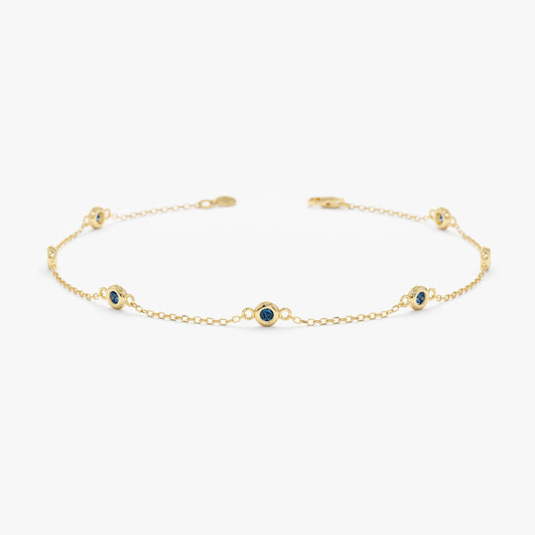 blue topaz bezel station bracelet in solid gold 