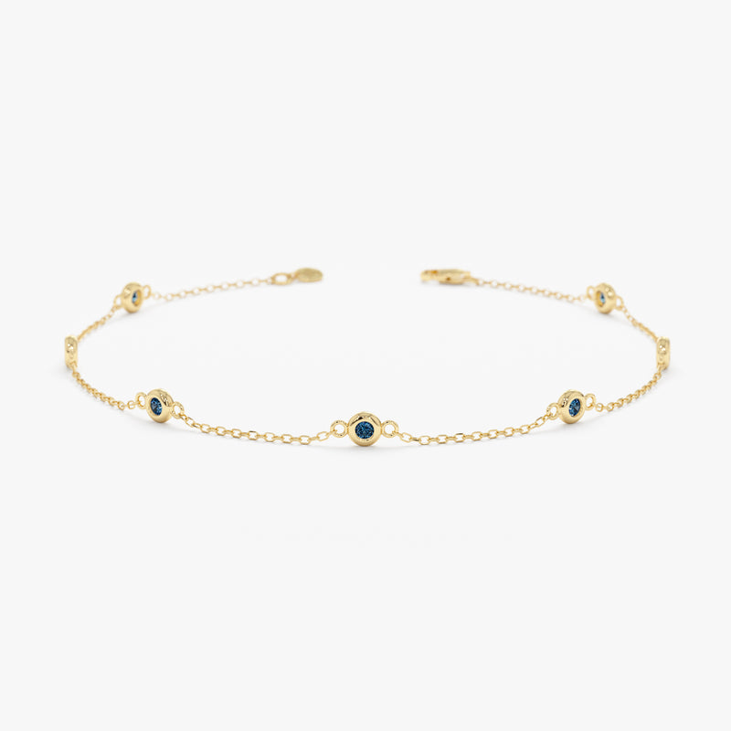 blue topaz bezel station bracelet in solid gold 