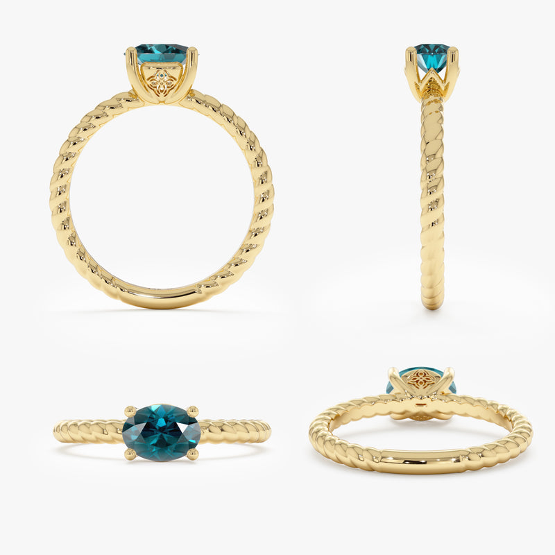 solid gold ring with single natural teal sapphire