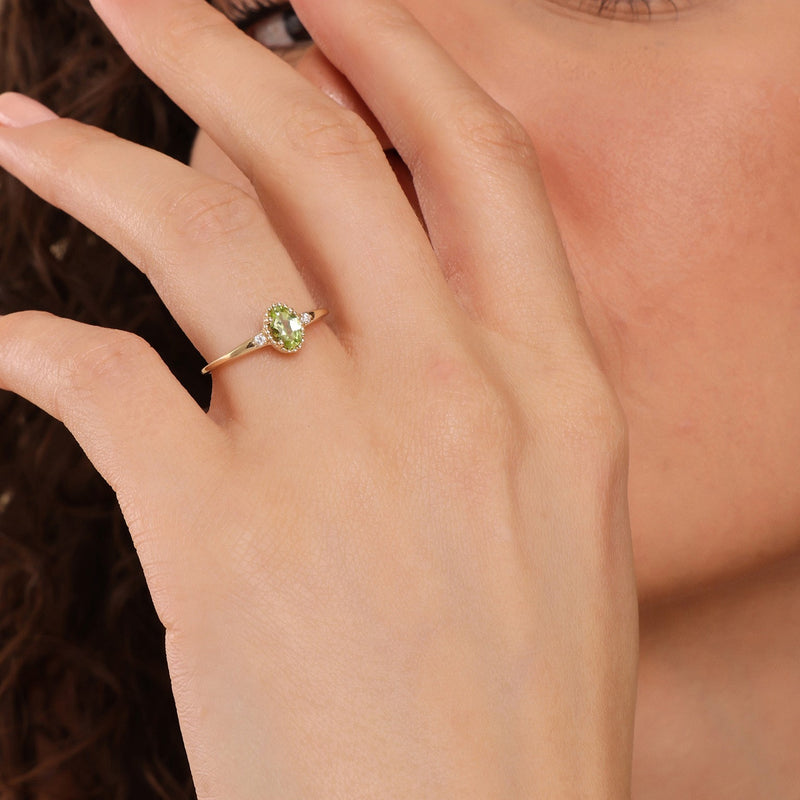 solid gold engagement ring with oval cut peridot