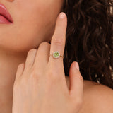 august birthstone peridot engagement ring with diamond halo on solid gold band 