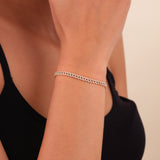 Solid gold Cuban link bracelet encrusted with sparkling diamonds for a luxurious look.