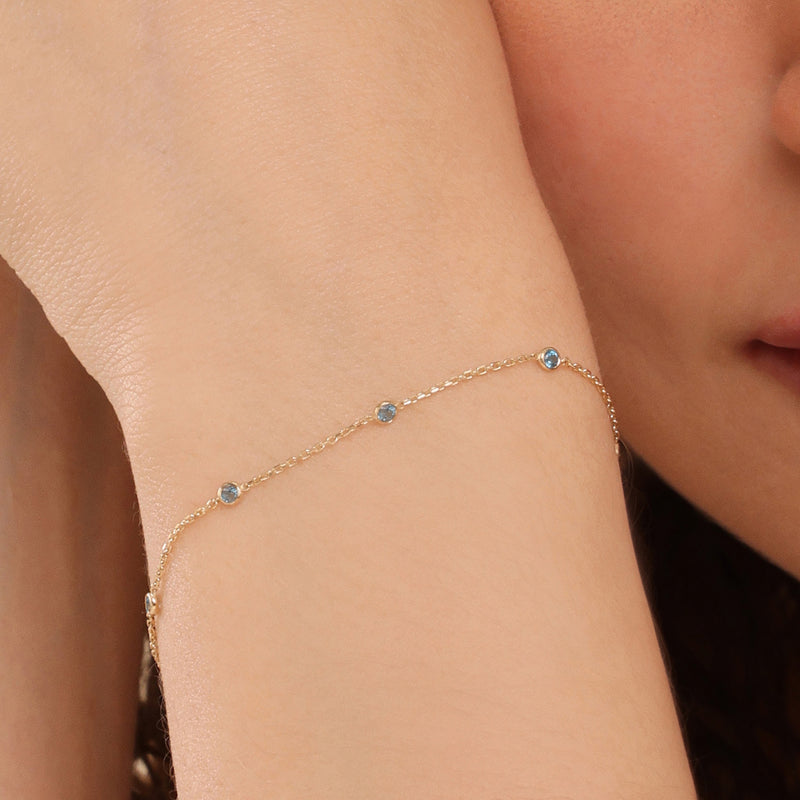 natural blue topaz bezel station bracelet in 14k solid gold 