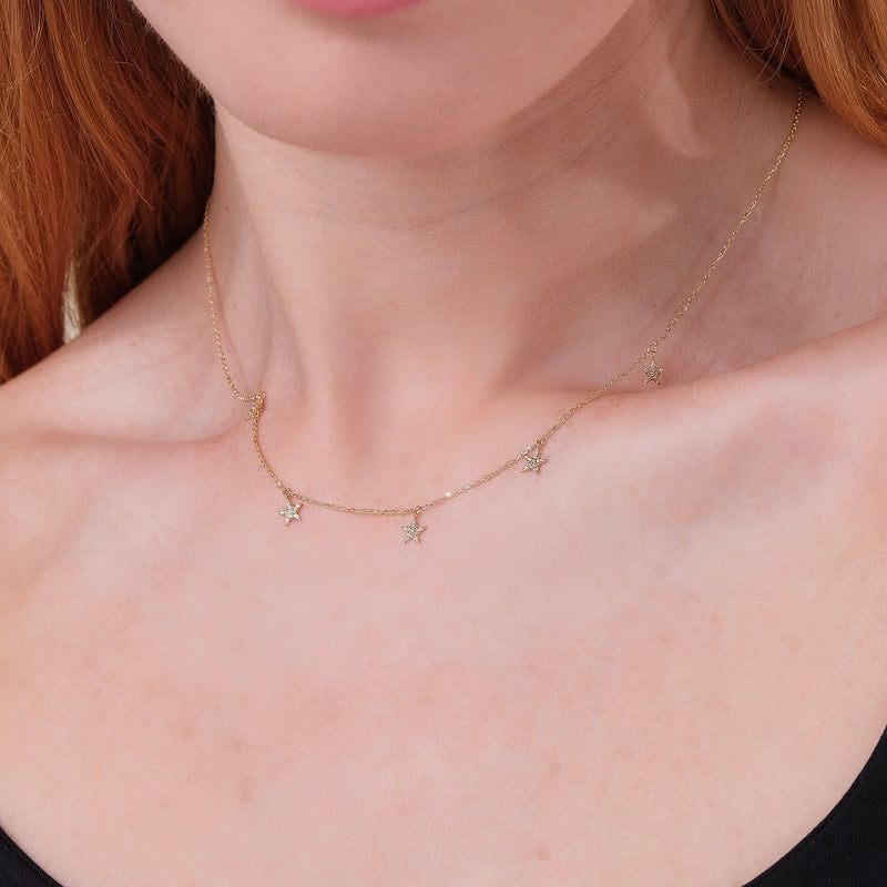 dainty solid gold necklace with multiple hanging star charms with natural diamonds for her