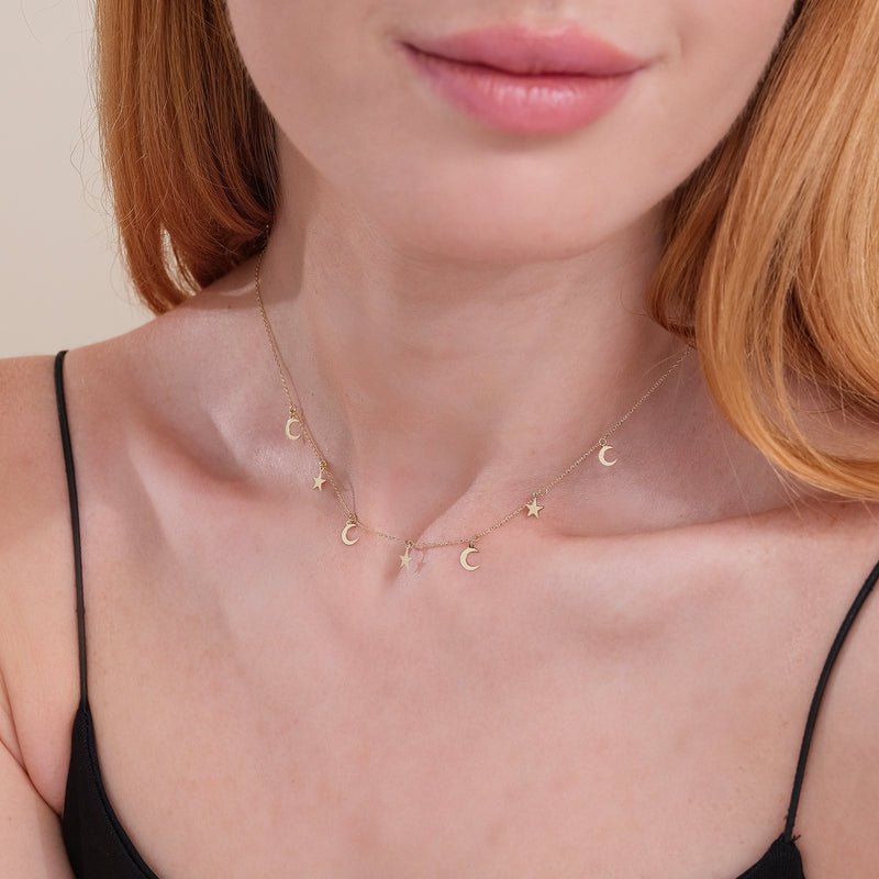 dainty hanging moon and star charm necklace in solid gold