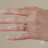 green oval cut peridot ring in solid gold