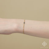 Dainty London blue topaz bracelet on a delicate gold Cuban chain, perfect for December birthdays.