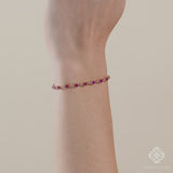  Vibrant tennis bracelet with alternating diamonds and rubies on a gold band