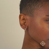 video close up of model wearing multi Bezel Diamond mini hoop earrings in solid gold for her