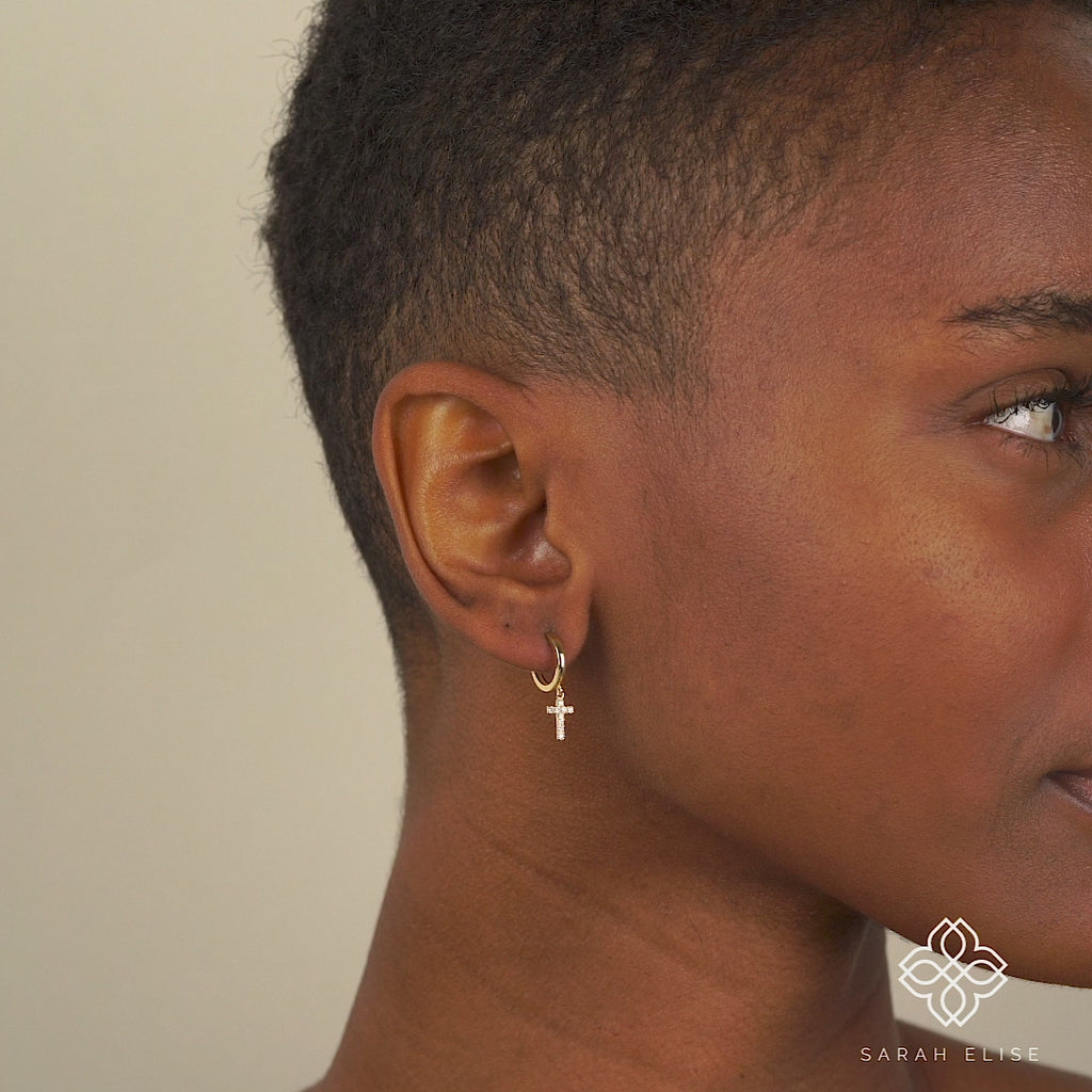 Video close up of model wearing Minimalist Diamond Cross Earrings