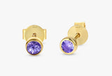 handmade pair of solid 14k gold stud earrings with amethyst bezel