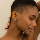 Model wears dainty Emerald Palm Leaf Stud earring for her