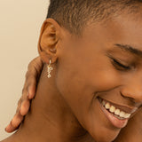 Model wears Natural Diamond Love Huggie earring