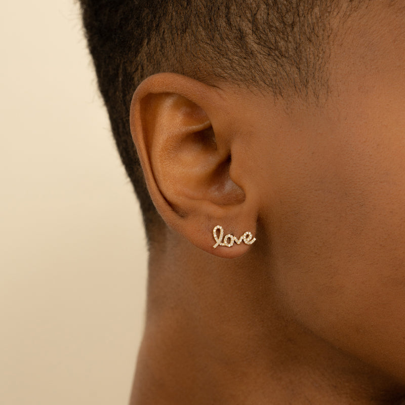 Model wears dainty Natural Diamond encrusted Love Earrings