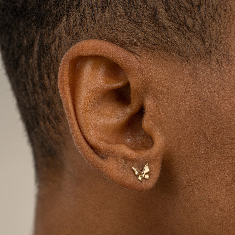 Model wears solid Gold Butterfly stud Earrings