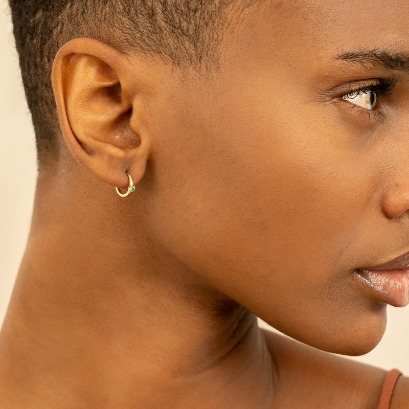 Model wears Tiny solid 14k Gold Diamond Huggie Earrings