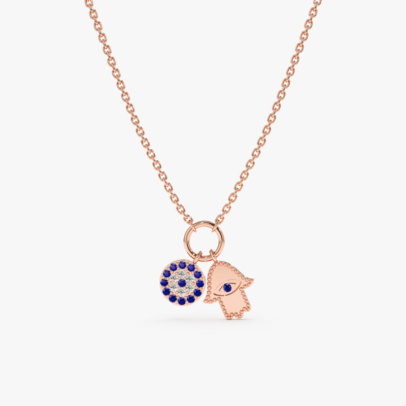 Elegant and protective Evil Eye & Hamsa Charm Necklace crafted in solid rose gold with sparkling gemstones.