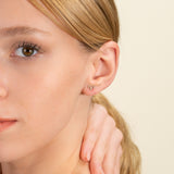 Model wears dainty Minimalist Diamond Aries Stud earring