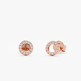 handcrafted pair of 14k solid rose gold halo disc stud earrings lined in diamonds 