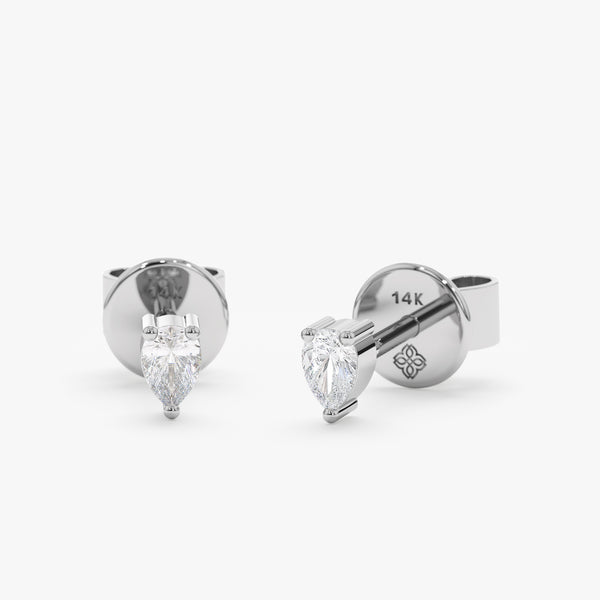handcrafted pair of solid 14k white gold stud earrings with pear cut diamond