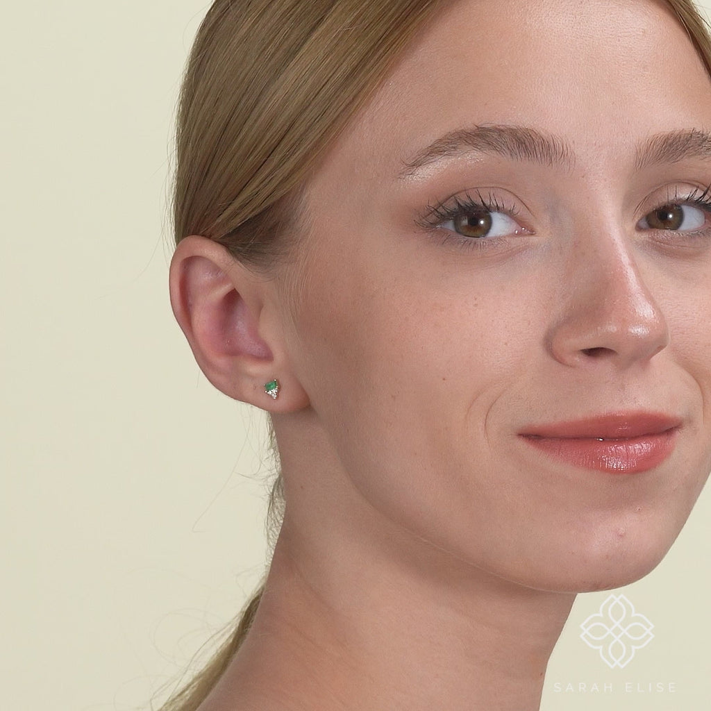 Video close up of green Natural Baguette Emerald and Round Diamond Studs