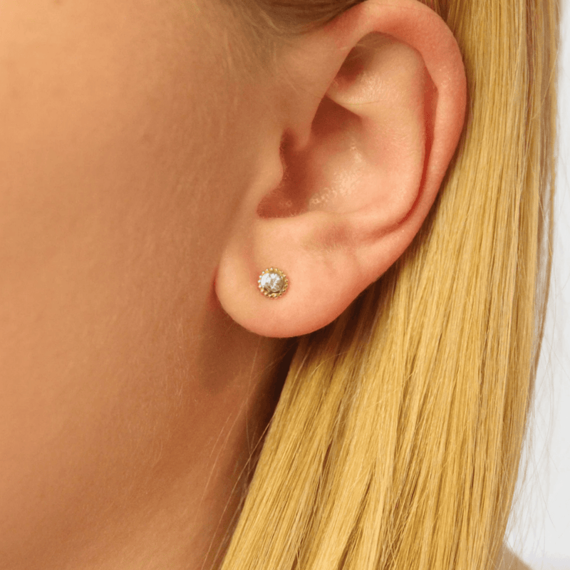 Model wears 14k solid gold earring stud in art deco style with sapphire gift for her