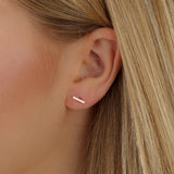 model wears dainty handcrafted gold bar studs